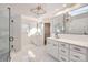 Elegant bathroom with double vanity, marble tile, and skylight at 18038 Greyfield Gln, Fort Mill, SC 29707