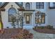 Inviting front entrance with arched windows and a dark gray door at 18038 Greyfield Gln, Fort Mill, SC 29707