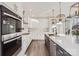 Modern kitchen with white cabinets, geometric backsplash and stainless steel appliances at 18038 Greyfield Gln, Fort Mill, SC 29707