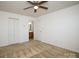 Bright bedroom with ceiling fan and ensuite bathroom at 1812 Hooper Ct, Charlotte, NC 28212