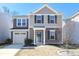 Two-story house featuring a neutral color scheme and a neatly landscaped yard at 1812 Hooper Ct, Charlotte, NC 28212