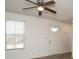 Living room with ceiling fan, window blinds, and wood-look floors at 1812 Hooper Ct, Charlotte, NC 28212