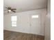 Living room with ceiling fan, window blinds, and wood-look floors at 1812 Hooper Ct, Charlotte, NC 28212