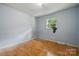 Neutral bedroom featuring wood floors, a window overlooking a serene view, and ample natural light at 1901 Ashcraft Ave, Monroe, NC 28110