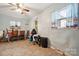 Casual dining area with light blue walls, ceiling fan, and view from a window with accent curtains at 1901 Ashcraft Ave, Monroe, NC 28110