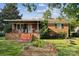 Charming brick home with a covered front porch and a small garden, creating a welcoming curb appeal at 1901 Ashcraft Ave, Monroe, NC 28110