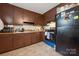 Traditional kitchen with brown cabinetry, updated appliances, and functional layout at 1901 Ashcraft Ave, Monroe, NC 28110