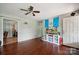 Bright living room with hardwood floors, ceiling fan, and access to other rooms at 1901 Ashcraft Ave, Monroe, NC 28110