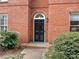 Black front door with arched transom window, brick facade at 2031 Queens W Rd, Charlotte, NC 28207