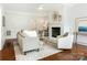 Living room with fireplace, hardwood floors, and neutral decor at 2031 Queens W Rd, Charlotte, NC 28207