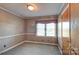 Bright bedroom with wood paneling and a window at 211 Roy Eaker Rd, Cherryville, NC 28021