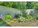 Landscaped backyard with lush greenery, flowers, and a birdbath at 2714 Selwyn Ave, Charlotte, NC 28209