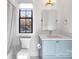 Charming bathroom with light blue vanity and a window at 2714 Selwyn Ave, Charlotte, NC 28209