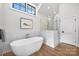 Spa-like bathroom featuring a freestanding tub and walk-in shower at 2714 Selwyn Ave, Charlotte, NC 28209