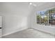 Spacious bedroom with large window and grey carpeting at 2714 Selwyn Ave, Charlotte, NC 28209