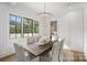 Elegant dining room with a chandelier, hardwood floors, and large windows at 2714 Selwyn Ave, Charlotte, NC 28209