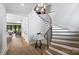 Elegant entryway with curved staircase, hardwood floors, and a view of the living room at 2714 Selwyn Ave, Charlotte, NC 28209