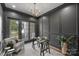 Elegant home office with dark gray walls, glass desk, and ample natural light at 2714 Selwyn Ave, Charlotte, NC 28209