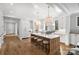 Modern kitchen with white cabinets, a large island, and hardwood floors at 2714 Selwyn Ave, Charlotte, NC 28209