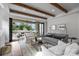 Light-filled living room with hardwood floors, exposed beams, and sliding glass doors at 2714 Selwyn Ave, Charlotte, NC 28209