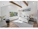 Main bedroom with vaulted ceiling, exposed beams, and a chic white bed at 2714 Selwyn Ave, Charlotte, NC 28209