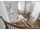 Upper landing overlooking the main floor with a large window and hardwood floors at 2714 Selwyn Ave, Charlotte, NC 28209