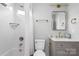 Modern bathroom with white tile and gold fixtures at 30 Walnut Nw Ave, Concord, NC 28027