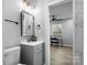 Bathroom with gray vanity, a large mirror, and a toilet at 30 Walnut Nw Ave, Concord, NC 28027