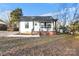 Charming white cottage with a covered porch and brick accents at 30 Walnut Nw Ave, Concord, NC 28027