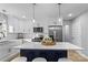 Modern kitchen featuring white cabinets, stainless steel appliances, and a large island at 30 Walnut Nw Ave, Concord, NC 28027