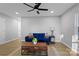 Living room with a blue couch, coffee table, and a ceiling fan at 30 Walnut Nw Ave, Concord, NC 28027