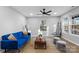 Living room features blue sofa, coffee table, and large windows at 30 Walnut Nw Ave, Concord, NC 28027