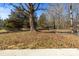 Large backyard with a chain link fence and mature trees at 322 Timber Rd, Iron Station, NC 28080