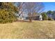 Private backyard with large trees and a chain link fence at 322 Timber Rd, Iron Station, NC 28080