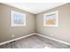 Well-lit bedroom featuring wood-look floors and two windows at 322 Timber Rd, Iron Station, NC 28080