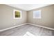 Spacious bedroom with two windows and wood-look floors at 322 Timber Rd, Iron Station, NC 28080