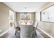 Bright dining room with hardwood floors, wood table, and stylish gray chairs at 322 Timber Rd, Iron Station, NC 28080