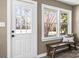 Inviting entryway with a charming bench and white door at 322 Timber Rd, Iron Station, NC 28080