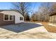 Large side yard with concrete patio and mature trees at 322 Timber Rd, Iron Station, NC 28080