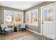 Bright sunroom with two comfy armchairs and large windows at 322 Timber Rd, Iron Station, NC 28080