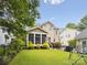 Landscaped backyard with a screened porch and play area at 3277 Richards Xing, Fort Mill, SC 29708