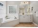 Bathroom with corner soaking tub and white cabinets at 3277 Richards Xing, Fort Mill, SC 29708