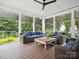 Screened porch with wooden floors and wicker furniture at 3277 Richards Xing, Fort Mill, SC 29708