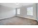 Bright bedroom with neutral walls, carpet, and two windows at 3405 Taviston Dr, Waxhaw, NC 28173