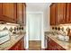 Butlers pantry with granite countertops and wood cabinets at 3405 Taviston Dr, Waxhaw, NC 28173