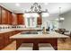 Granite kitchen island with gas cooktop and breakfast bar at 3405 Taviston Dr, Waxhaw, NC 28173