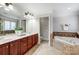 Main bathroom with double vanity, soaking tub, and separate shower at 3405 Taviston Dr, Waxhaw, NC 28173