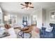 Bright sunroom features hardwood floors, comfy seating, and ample natural light at 3405 Taviston Dr, Waxhaw, NC 28173