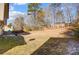 Large backyard with sloped terrain and trees at 502 Long Creek Pkwy, Charlotte, NC 28214