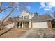 Brick and vinyl two-story house with a two-car garage and a covered front porch at 502 Long Creek Pkwy, Charlotte, NC 28214